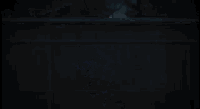 a person is holding a sword in their hand and a blue light is coming out of it