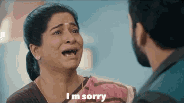 a woman is crying and says i 'm sorry to a man
