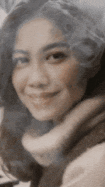 a close up of a woman 's face with a smile