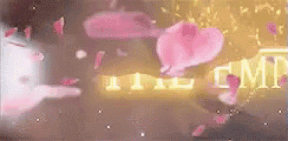 a pink heart is floating in the air in front of a sign that says `` the gmt '' .
