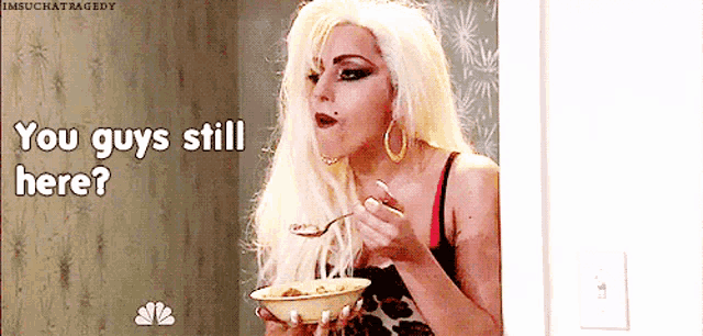 a woman with blonde hair is eating a bowl of cereal and says you guys still here .