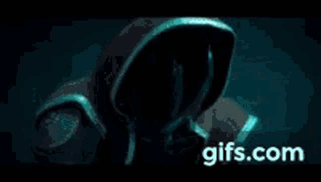 a close up of a person 's face in a dark room with the words `` gifs.com '' on the bottom .