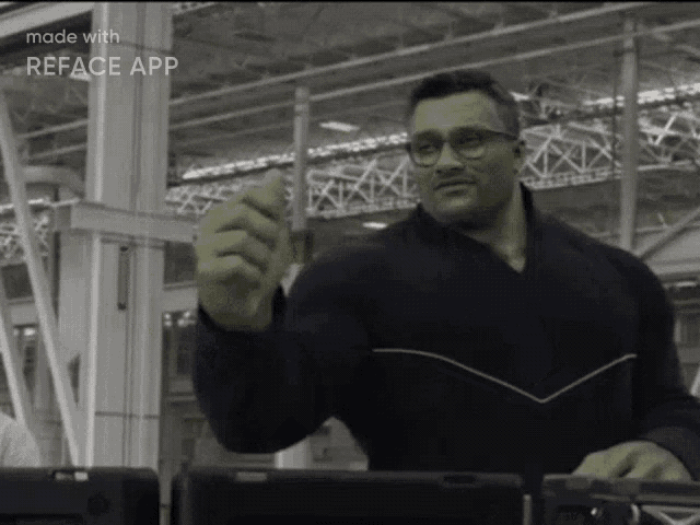 a man wearing glasses is giving a thumbs up in a black and white photo made with the reface app
