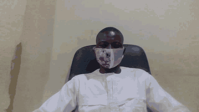 a man wearing a white shirt and a face mask
