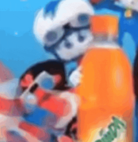 a blurry picture of a person holding a bottle of orange soda