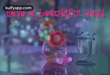 a vase of flowers is sitting on a table next to a candle holder .