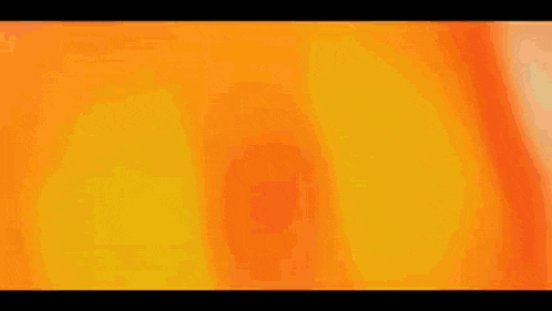 a black and orange background with a gradient in the middle .