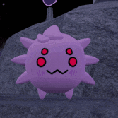 a purple pokemon with red eyes and a big smile on its face is sitting on a white surface .