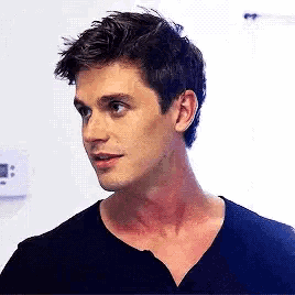 a man with a scar on his neck is wearing a black t-shirt