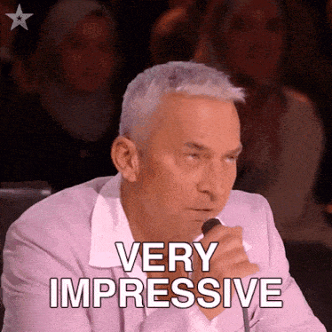 a man speaking into a microphone with the words very impressive behind him