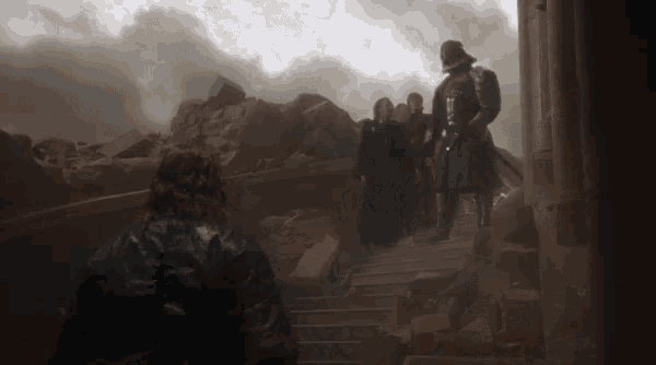 a group of people are walking down a set of stairs with a man wearing a helmet