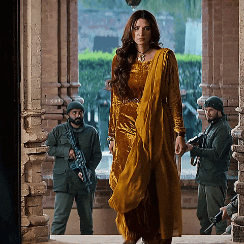 a woman in a yellow dress is standing in front of soldiers