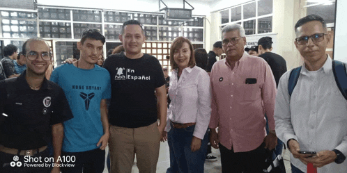 a group of people posing for a picture with one man wearing a shirt that says en faith espanol