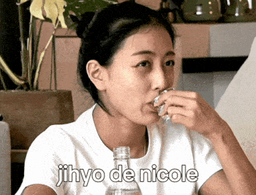 a woman drinking from a bottle with the words jihyo de nicole written below her