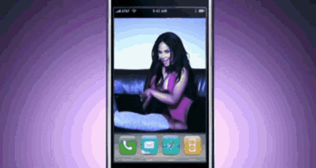 a cell phone displays a picture of a woman sitting on a couch
