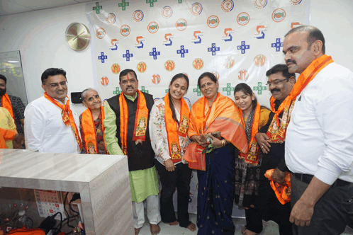 a group of people are posing for a picture in front of a wall that has the number 5 on it
