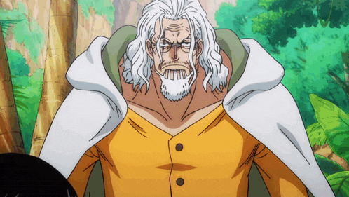 a man with white hair and a beard is wearing a yellow shirt and a white cape