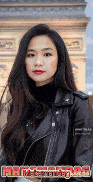 a woman wearing a black leather jacket and red lipstick stands in front of a building with the words mama mamandag written below her