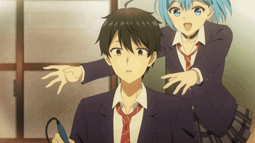 a boy in a suit and tie is standing next to a girl with blue hair
