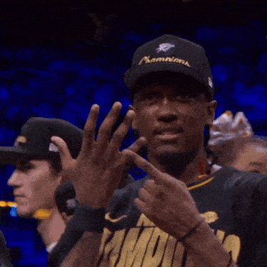 a man wearing a hat and a shirt that says ' miami ' on it