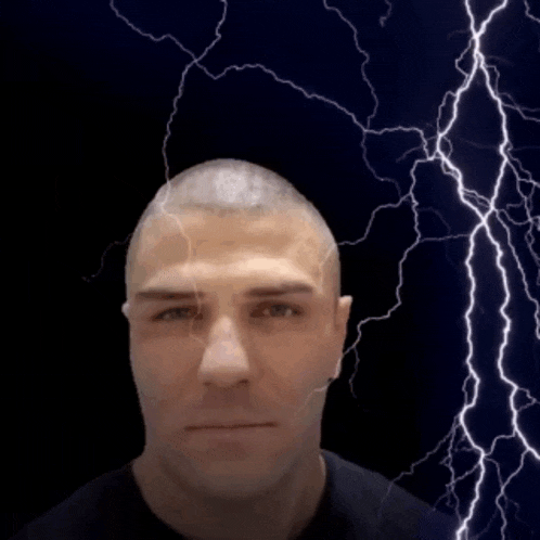 a man 's head is being struck by a lightning bolt