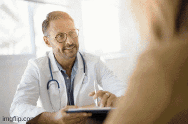 a doctor is talking to a patient and taking notes