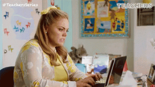 a woman is sitting in front of a laptop computer .