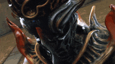 a close up of a statue of a monster with a crown on it
