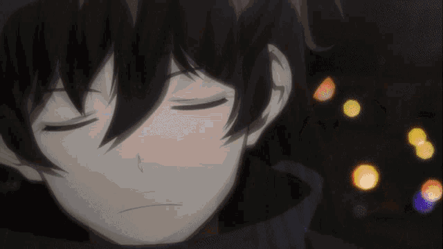 a close up of a person 's face with their eyes closed in the dark