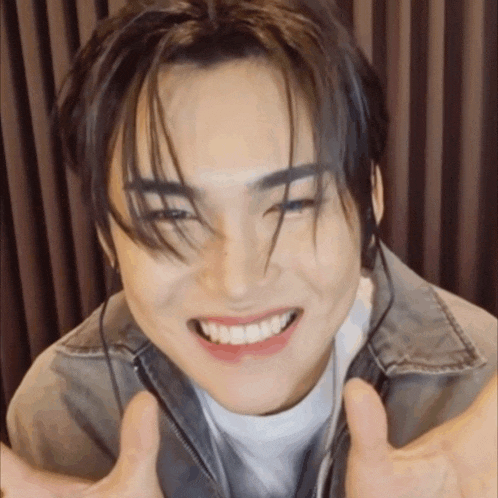a close up of a person 's face with a big smile on their face