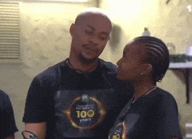a man and a woman are standing next to each other and the man has a shirt that says 100 years on it