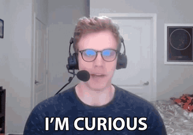 a man wearing glasses and a headset says i 'm curious