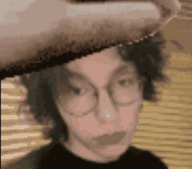 a close up of a person 's face with glasses