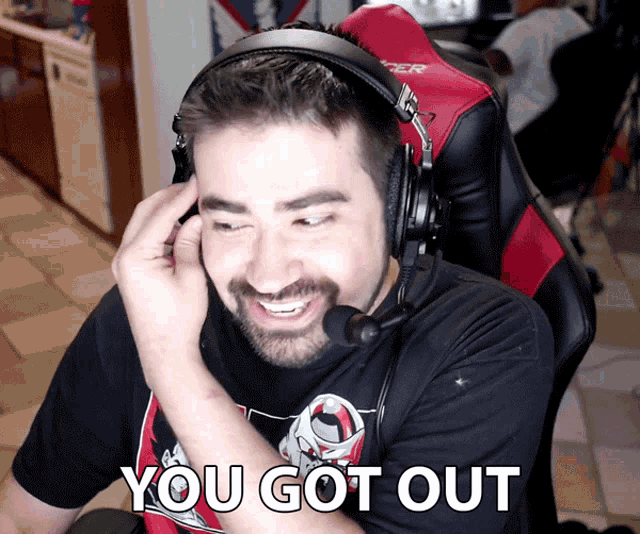 a man wearing headphones and a shirt that says ' you got out ' on it