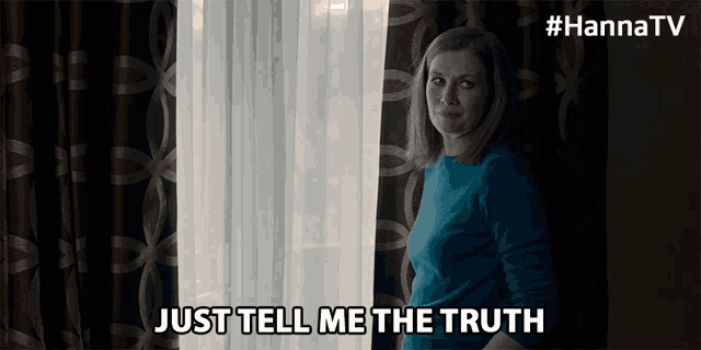 a woman standing in front of a window with the words just tell me the truth above her
