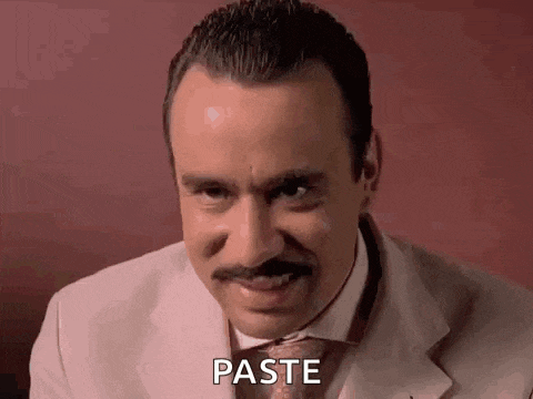 a man in a suit and tie with a mustache is making a funny face and saying paste .