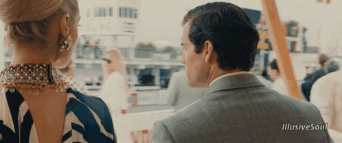 a man in a suit and a woman in a dress are looking at each other with the words illusive soul below