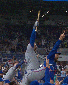a baseball player holds a bat in the air in front of a sign that says ' el sports network '