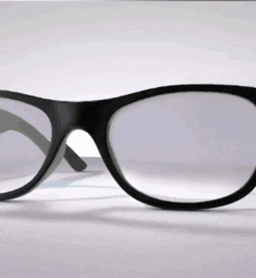 a pair of glasses with a black frame are sitting on a white surface .