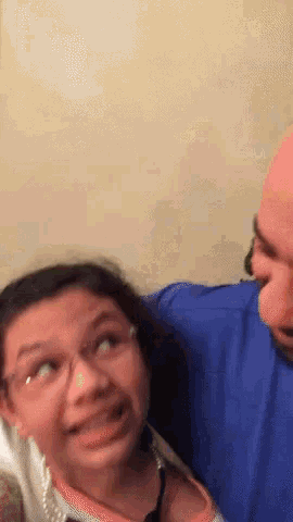 a man and a girl are making funny faces and the girl is wearing glasses