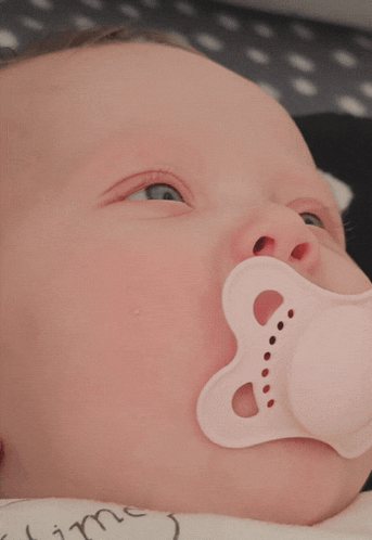a baby sleeping with a pacifier in his mouth