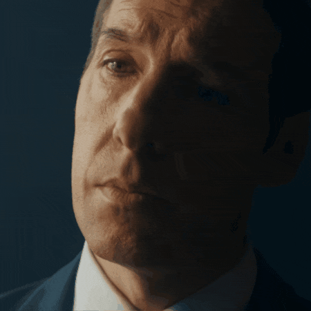 a close up of a man 's face with a serious look on his face