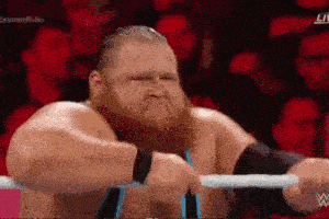 a man with a beard is standing in a wrestling ring with the word live on the bottom