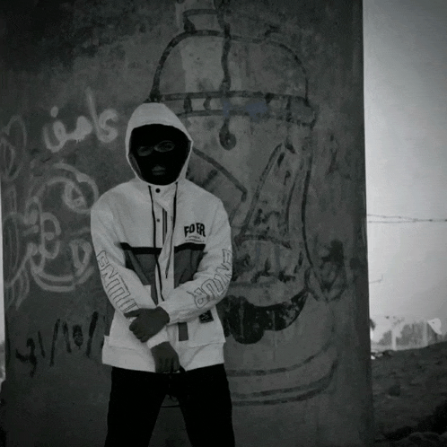 a man wearing a hooded jacket with the word for on it