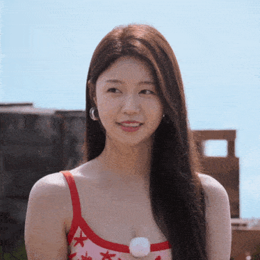 a woman in a red tank top with stars on it smiles