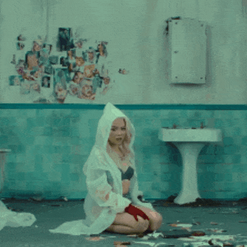 a woman is kneeling in front of a sign that says dallas film