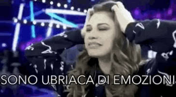 a woman with her eyes closed is holding her head and the words sono ubriaca di emozioni are written below her