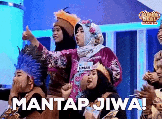 a group of people standing in front of a sign that says mantap jiwa !