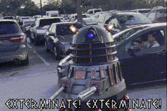 a robot in a parking lot with the words exterminate exterminate on it