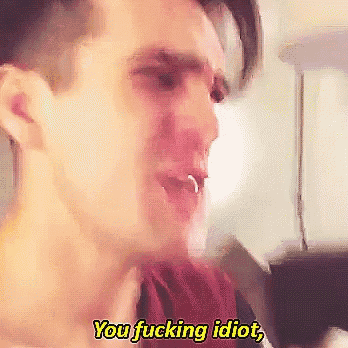 a close up of a man 's face with the words " you fucking idiot " above him